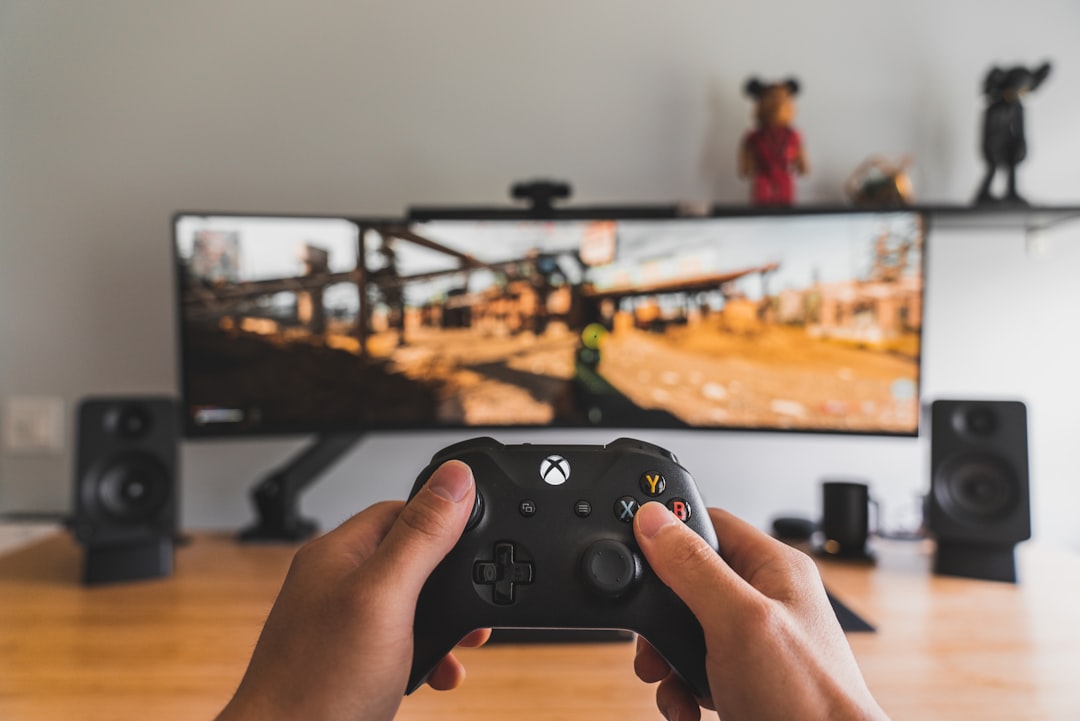 person-holding-black-game-controller-x6qffklwyoq